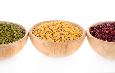 green beans, soy beans, red beans, wooden bowls on white background