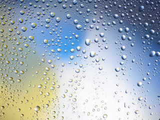 Naklejka na ściany i meble Water drops color background rain glass space rainbow.