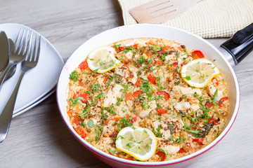 Paella with chicken, tomatoes and pepper . Traditional Spanish dish. Selective focus