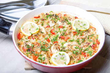 Paella with chicken, tomatoes and pepper . Traditional Spanish dish. Selective focus