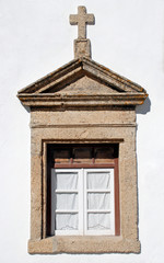 old window in stone rural church, Portugal.