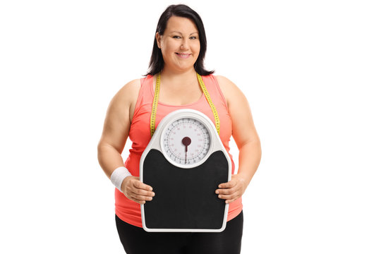 Overweight woman holding a weight scale