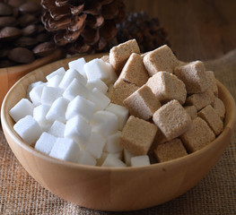 Sugar cubes white ,sugar cubes cane in bowl on wooden background