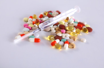 Colored pills lie on a paper cardiogram