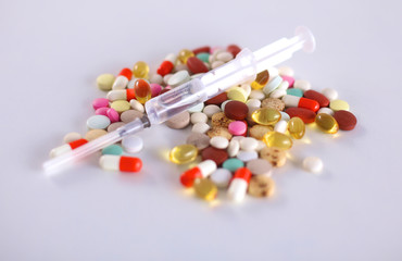 Colored pills lie on a paper cardiogram