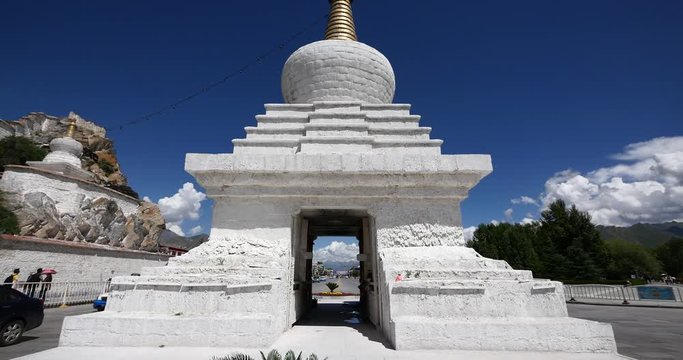 4k busy traffic & pedestrian through white stupa in Lhasa,Tibet.