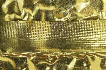 Macro photo of gold foil from packaging of Chinese tea.