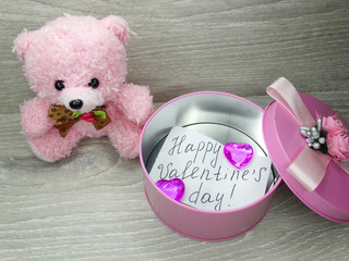valentine's day composition of gift box teddy bear and hearts