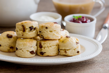 Homemade raisin scones served with homemade strawberries jam,clotted cream and tea.Scones is...