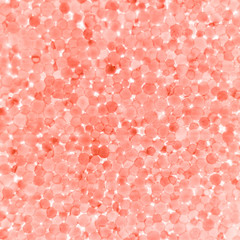 A square background of colored pink beads of styrofoam.