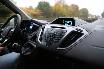 Fototapeta na wymiar balck luxury car from inside. Close up of steering wheel, seat and circuit