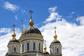 Fototapeta na wymiar Orthodox crosses on gold domes (cupolas) blue sky with clouds.