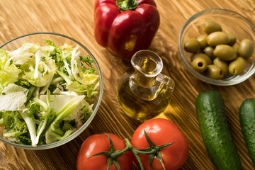 Salad ingridients. Tomato, lettuce, paprika, cucumber and olive oil.
