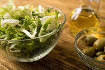 Salad leaves with olives and oil.