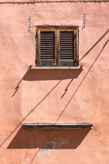 pink wall facade with closed window