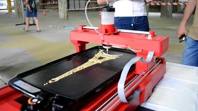 3d printer for liquid test. 3D printer printing pancakes with liquid dough different shapes close-up. Modern additive technologies 4.0 industrial revolution