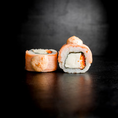 Japanese food. Tasty sushi rolls on black background. Restaurant food
