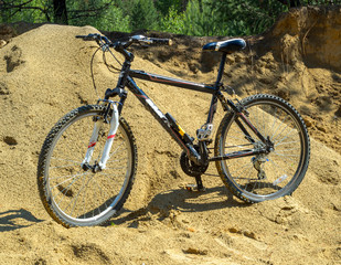 Fototapeta na wymiar Bicycle stands on the yellow sand