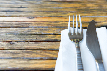 Fork and knife on wooden table