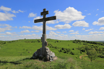 Fototapeta na wymiar Cross on green hill