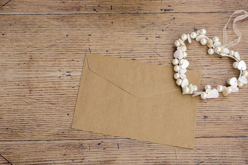 Brown envelope with pearl heart shape