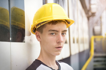 portrait of a young man with yellow safety helmet