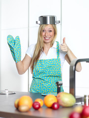 Happy baking cooking woman in her kitchen 
