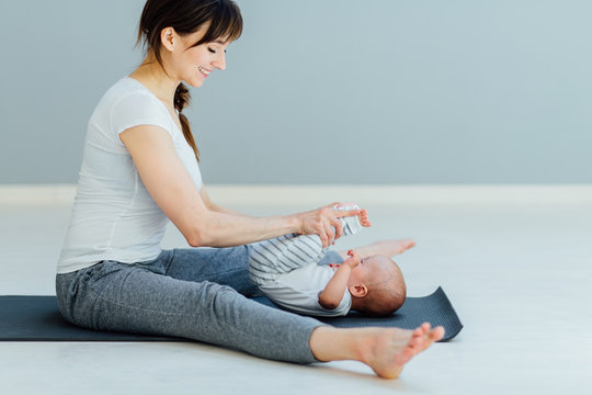 Young Sporty Other Doing Massage And Gymnastic Baby