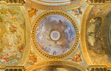 Fototapeta na wymiar TURIN, ITALY - MARCH 13, 2017: The neo - baroque cupola with motive Glory of St. Theresia and the Four Evangelists in church Chiesa di Santa Teresa by Luigi Vacca (1820).