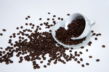 Coffee beans and cup of coffee on white background
