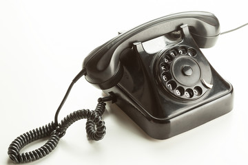Old rotary phone on white background