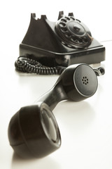 Old rotary phone on white background