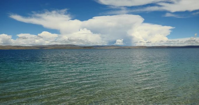 4k huge clouds mass rolling over lake namtso & Tanggula snow mountain peak,tibet mansarovar,pray flag in wind,Tibet's second largest lake,the third largest saltwater lake in China.roof of the World.