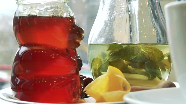 Green tea and honey on a table in a cafe - closeup