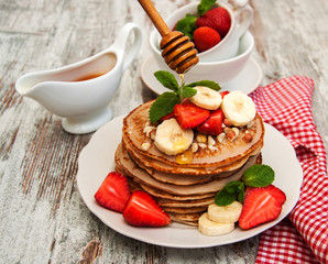 Pancakes with strawberries and bananas