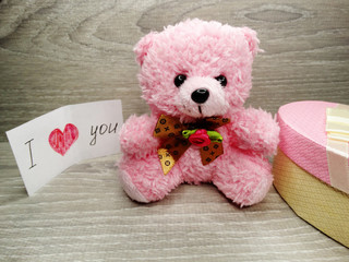 valentine's day composition of gift box teddy bear and hearts