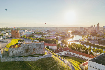 Fototapeta na wymiar Beautiful summer panorama of Vilnius with hot air balloons in the sky, taken over the Gediminas hill, drone aerial view