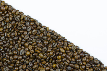 Close-up view of coffee beans surface isolated on white background with place for text