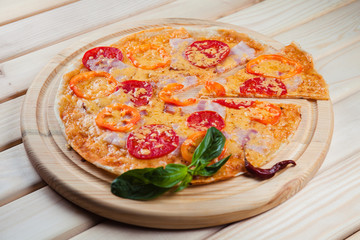 Spicy pizza on a wooden background
