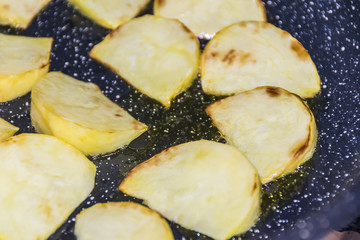 Large slices of potatoes are fried