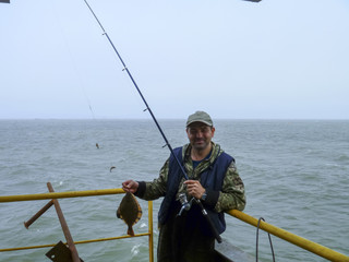 Flounder on the deck. Fishing on the boat. Bottom fish