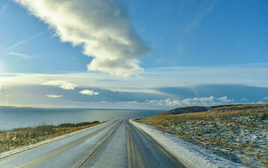 Empty road with an ocean view in winter season in Iceland