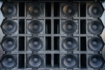 Speakers collage, useful image in a musical composition. Wall of large black music speakers.