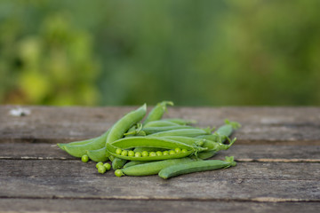 Green peas on wooden background