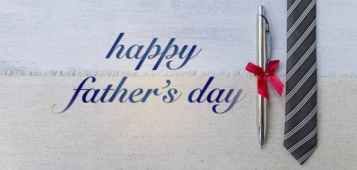 Happy father's day card concept, Silver pen and black necktie on canvas background