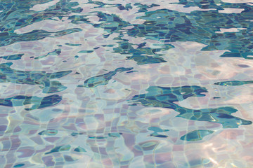 Blue pool water with sun reflections