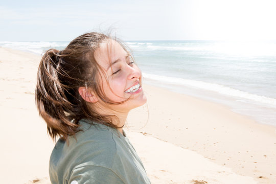 smiling happy cute teenager girl in ocean sea beach