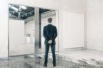 Fototapeta premium Businessman in room with whiteboard