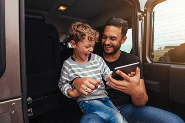 Young father and son having fun on road trip
