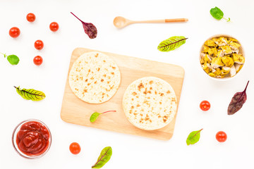Ingredients for cooking healthy Mexican dishes tacos. Chicken fillet, tomato, tortillas, corn on white background. Flat lay, top view